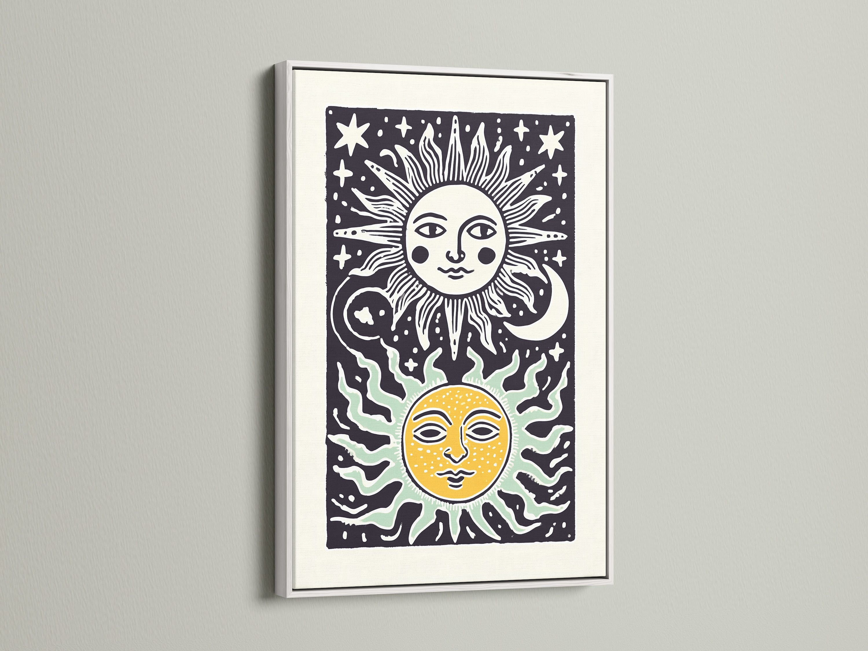 White frame highlights sun and moon art. The art features celestial elements. The frame offers a clean and modern look. The artwork is simple and elegant. The print stands out against the white wall. The artwork is eye-catching.