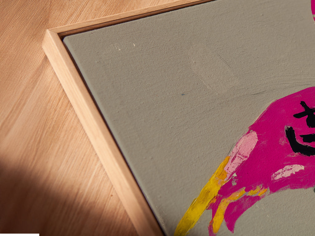 A close-up shot shows a canvas print in a floating frame. The artwork features a pink flamingo balancing on zen stones. The floating frame gives the art depth. It creates a visually stunning effect for any wall. Perfect meditation art.