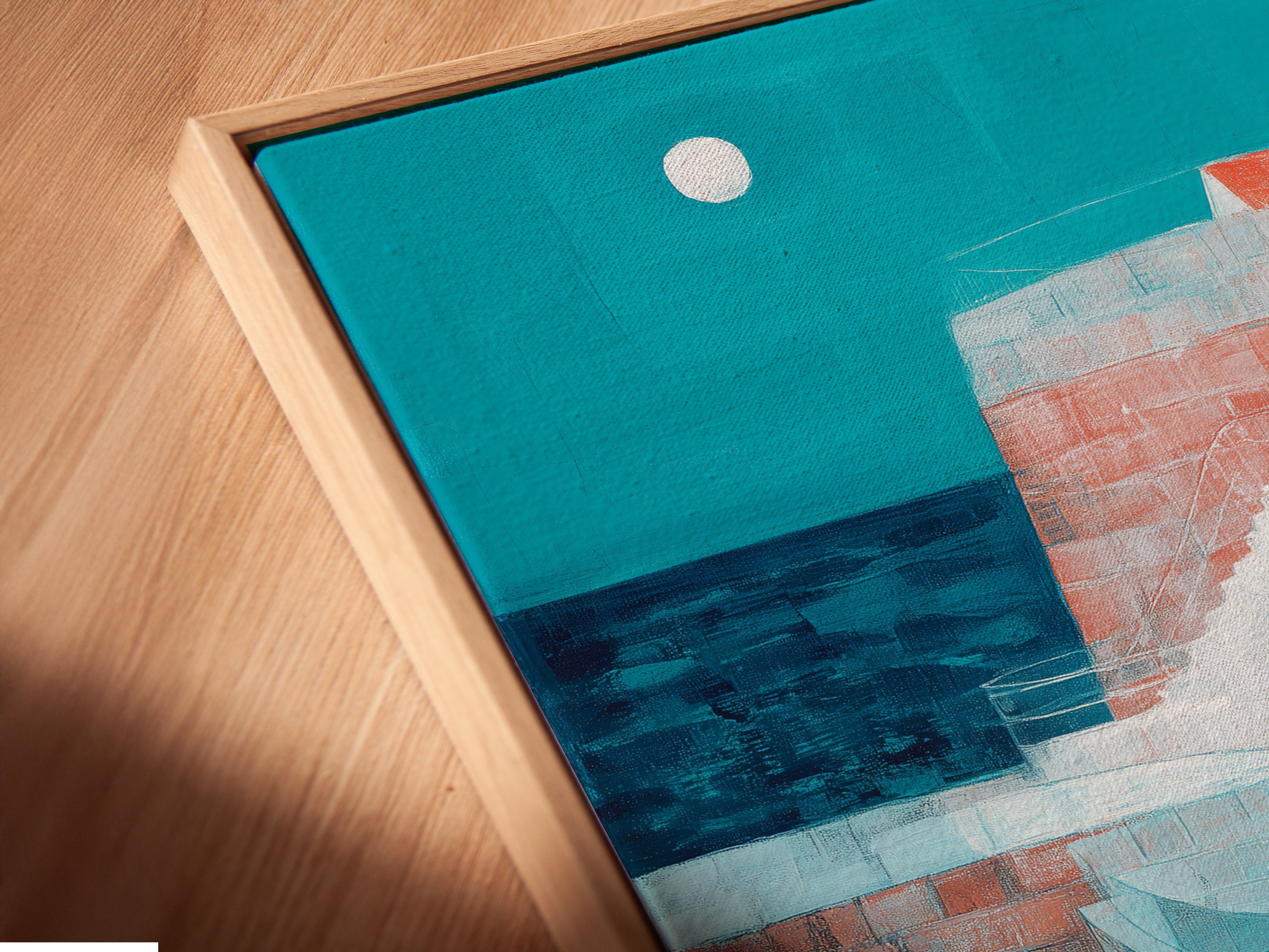 A close-up angled view of a canvas print in a floating frame. The artwork features a tranquil coastal village scene. The floating frame gives a modern gallery-like appearance. It allows the art to stand out without obstruction. Notice the fine details and textures of the print.