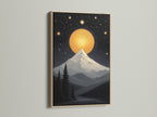 Modern mountain moon canvas print showcased in an oak frame. This celestial wall art features a cosmic landscape poster for bedroom wall decor. The oak frame enhances the night sky art and is great for living rooms and cozy reading nooks.
