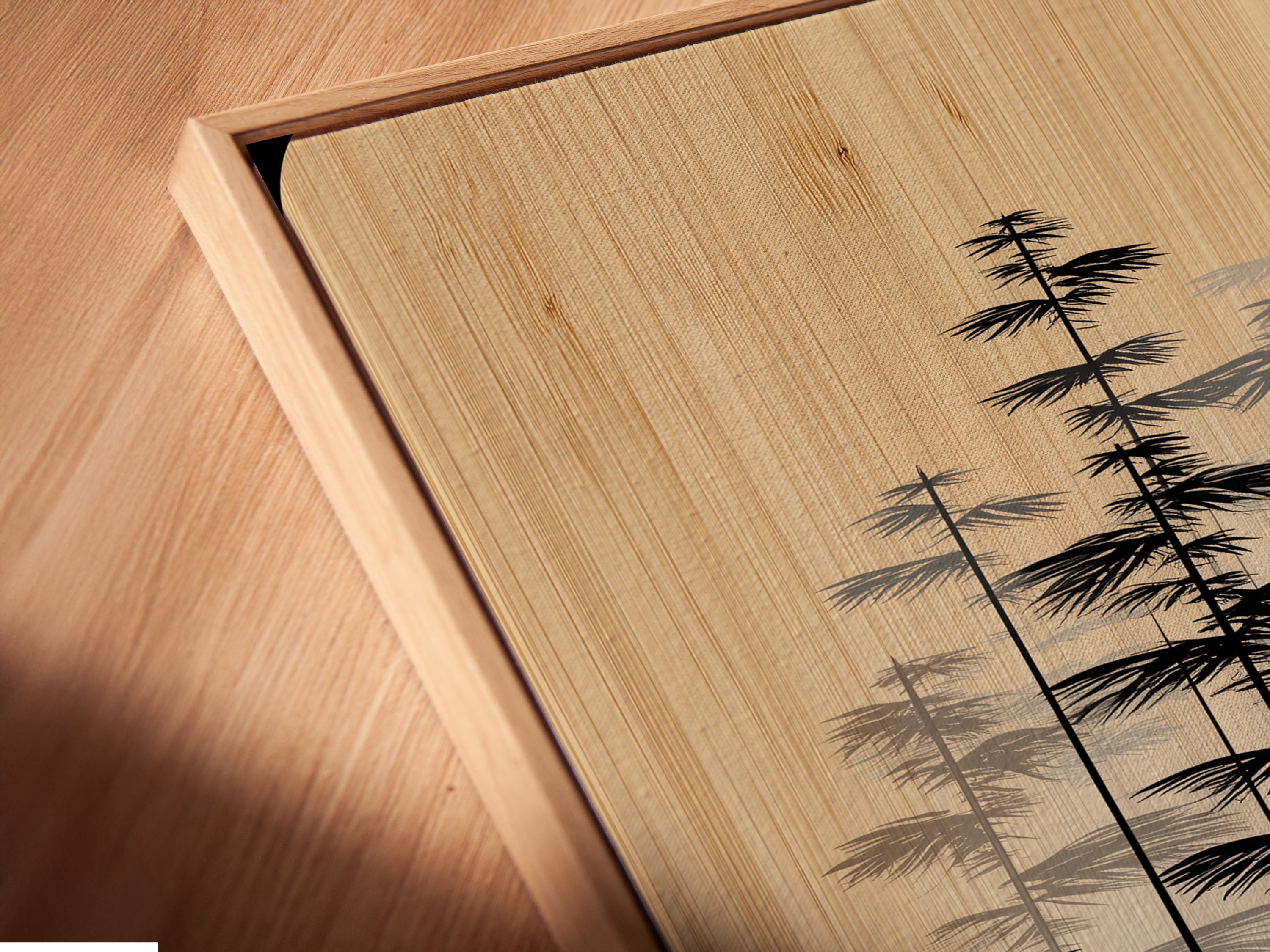 A close up angled view of a canvas print in a floating frame. The minimalist forest art is beautifully displayed. The Scandinavian wall decor is modern and chic. This neutral tone canvas enhances any room. The tree artwork is captivating.