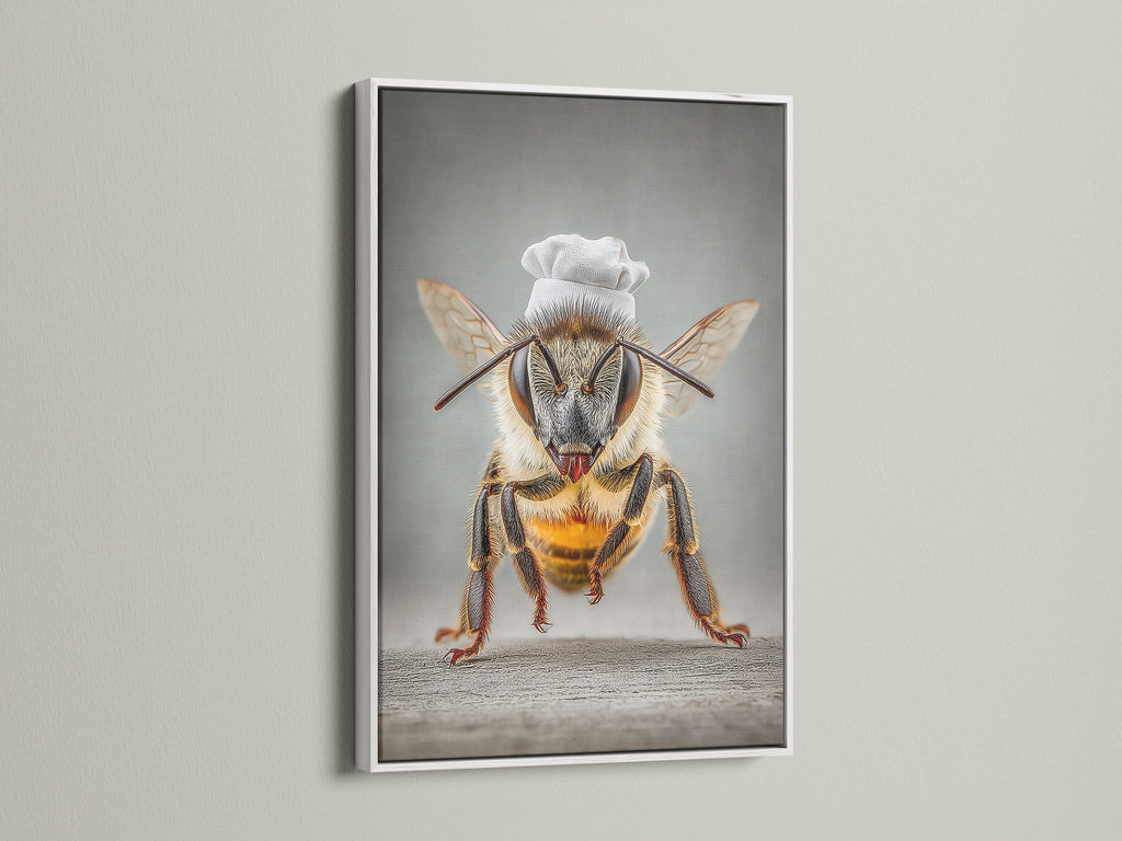 A white frame surrounds Chef Bee artwork. This adds a clean modern look. It's a quirky bee print that brightens any kitchen. It's whimsical decor for dining rooms. The white frame complements contemporary styles.