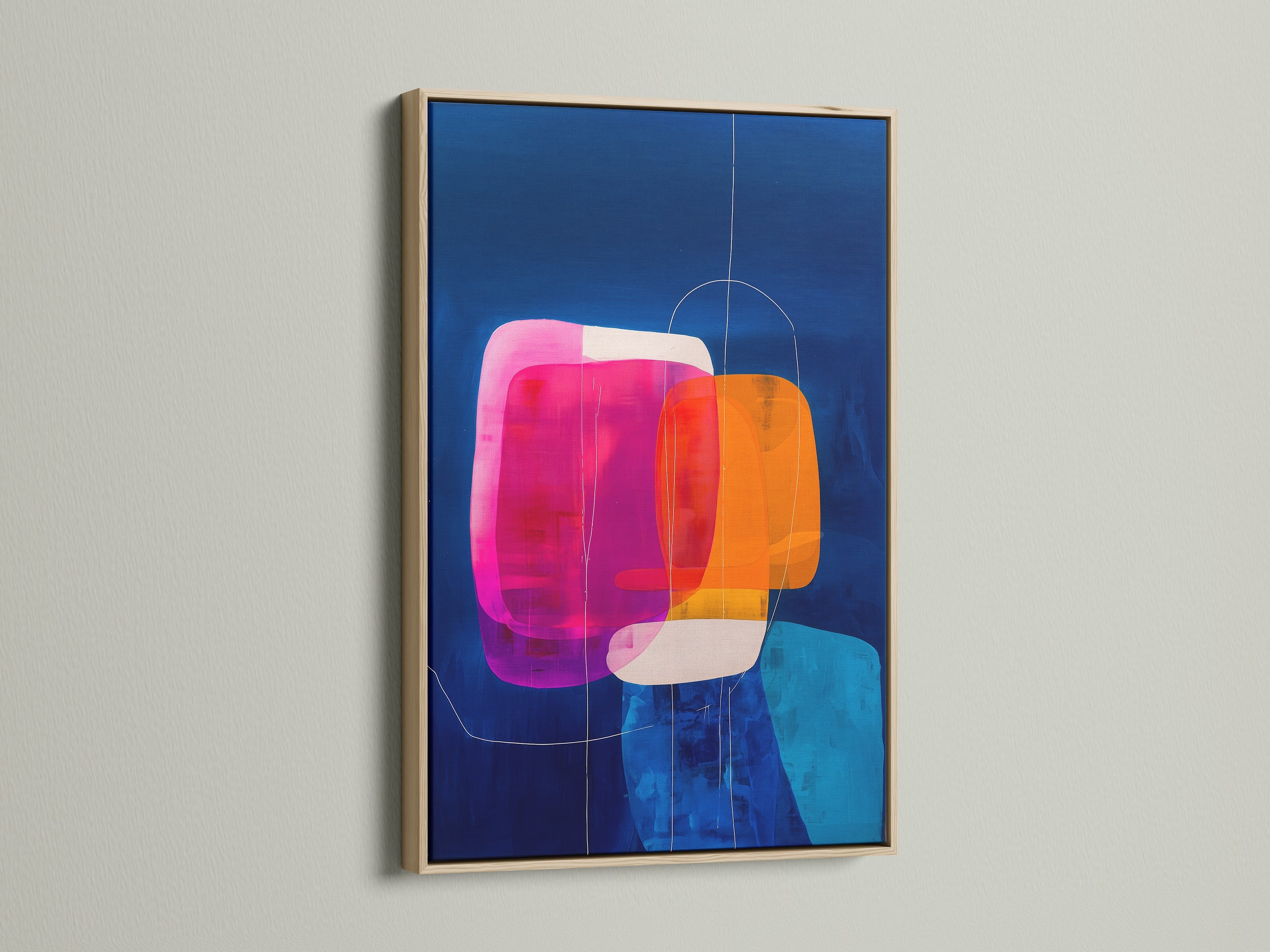 A vibrant abstract geometric print in an oak frame. The artwork features blue orange and pink colors. It hangs on a white wall. Ideal for adding a contemporary touch to your home or office wall decor
