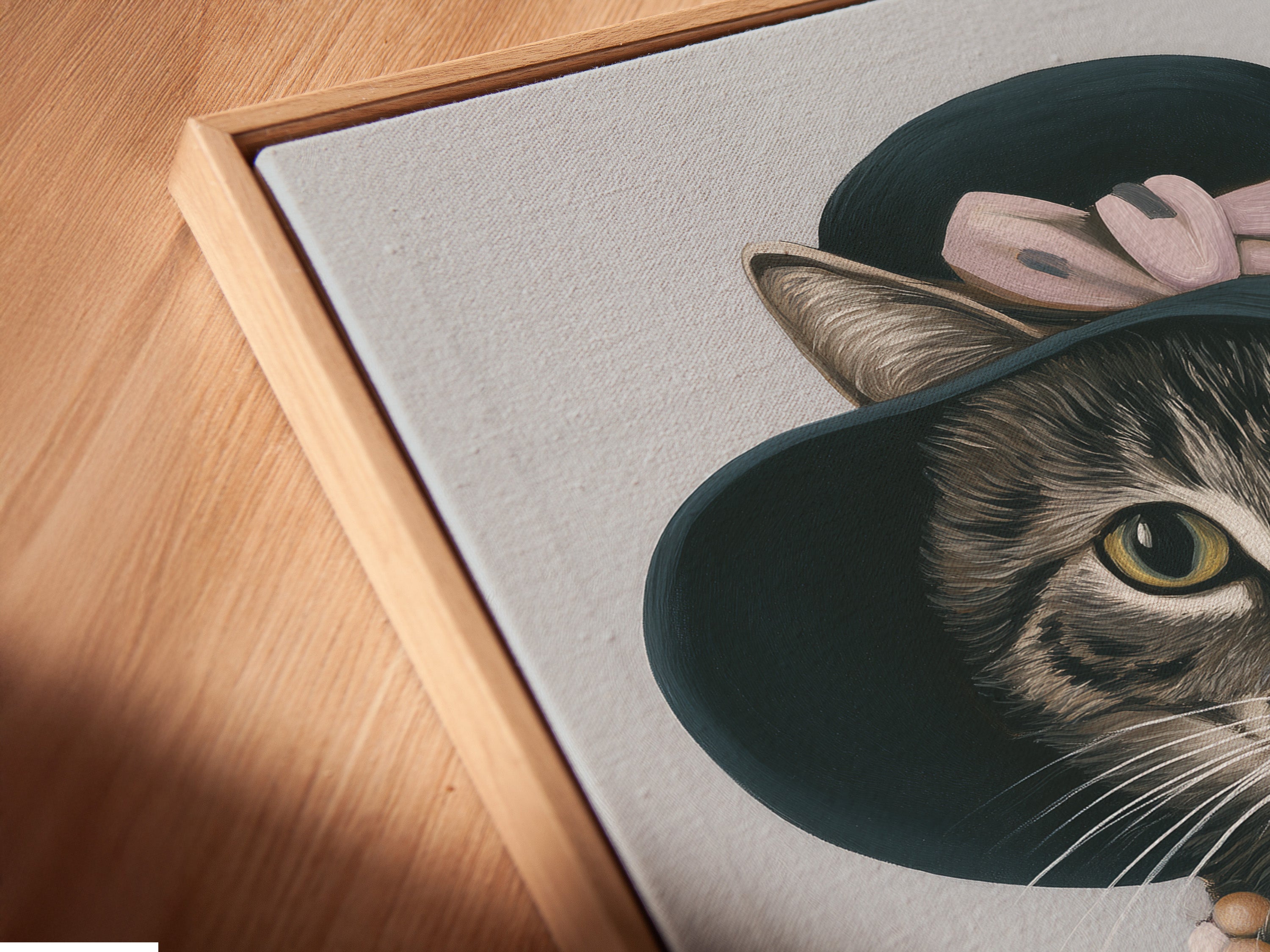 A close-up angled view of a canvas print in a floating frame. The vintage cat art is beautifully displayed. This portrait wall art is perfect for boutique wall decor. Bring feline art to studios and cafes.