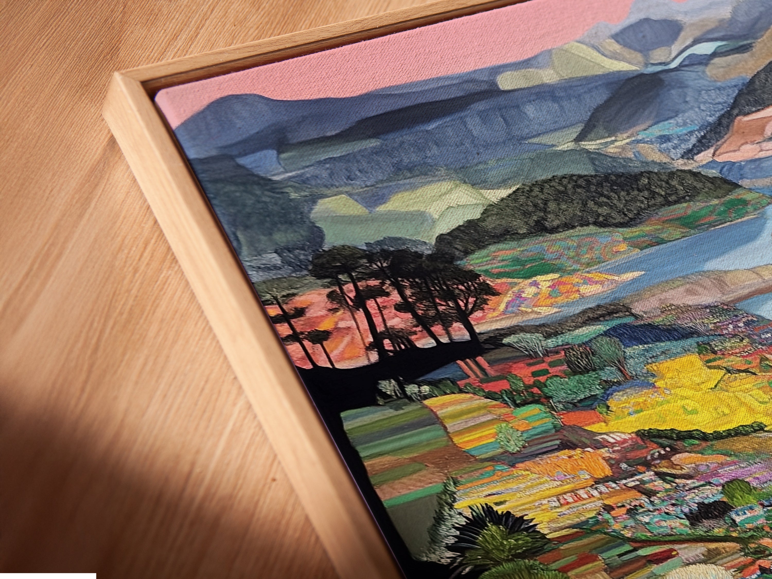 A close-up angled view of a canvas print in a floating frame. The colorful landscape artwork enhances any home decor. This modern nature artwork brings vibrancy to your walls. It is a great addition to living rooms bedrooms and offices. This whimsical decor adds charm