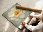 A woman is carefully rolling a fine art poster paper. The poster features the Lotus Flower artwork. This high-quality paper ensures vibrant colors. Ideal for those who appreciate fine details. Perfect for creating custom wall displays.