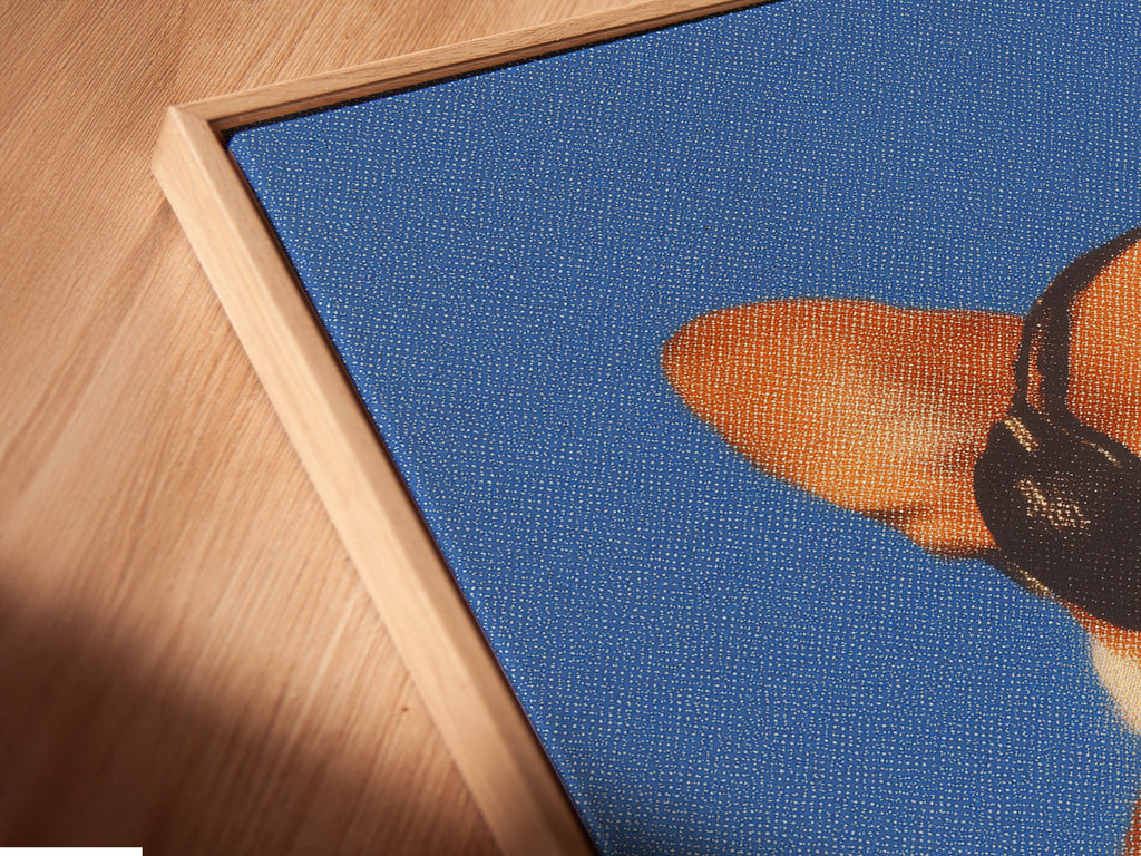Angled close up of a Corgi Music Artwork Print in floating frame. Dog listening to headphones canvas wall art. A blue pet portrait for office wall decor. Ideal for dog lovers seeking unique wall art. Appreciate a touch of whimsy in your home.
