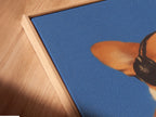 Angled close up of a Corgi Music Artwork Print in floating frame. Dog listening to headphones canvas wall art. A blue pet portrait for office wall decor. Ideal for dog lovers seeking unique wall art. Appreciate a touch of whimsy in your home.