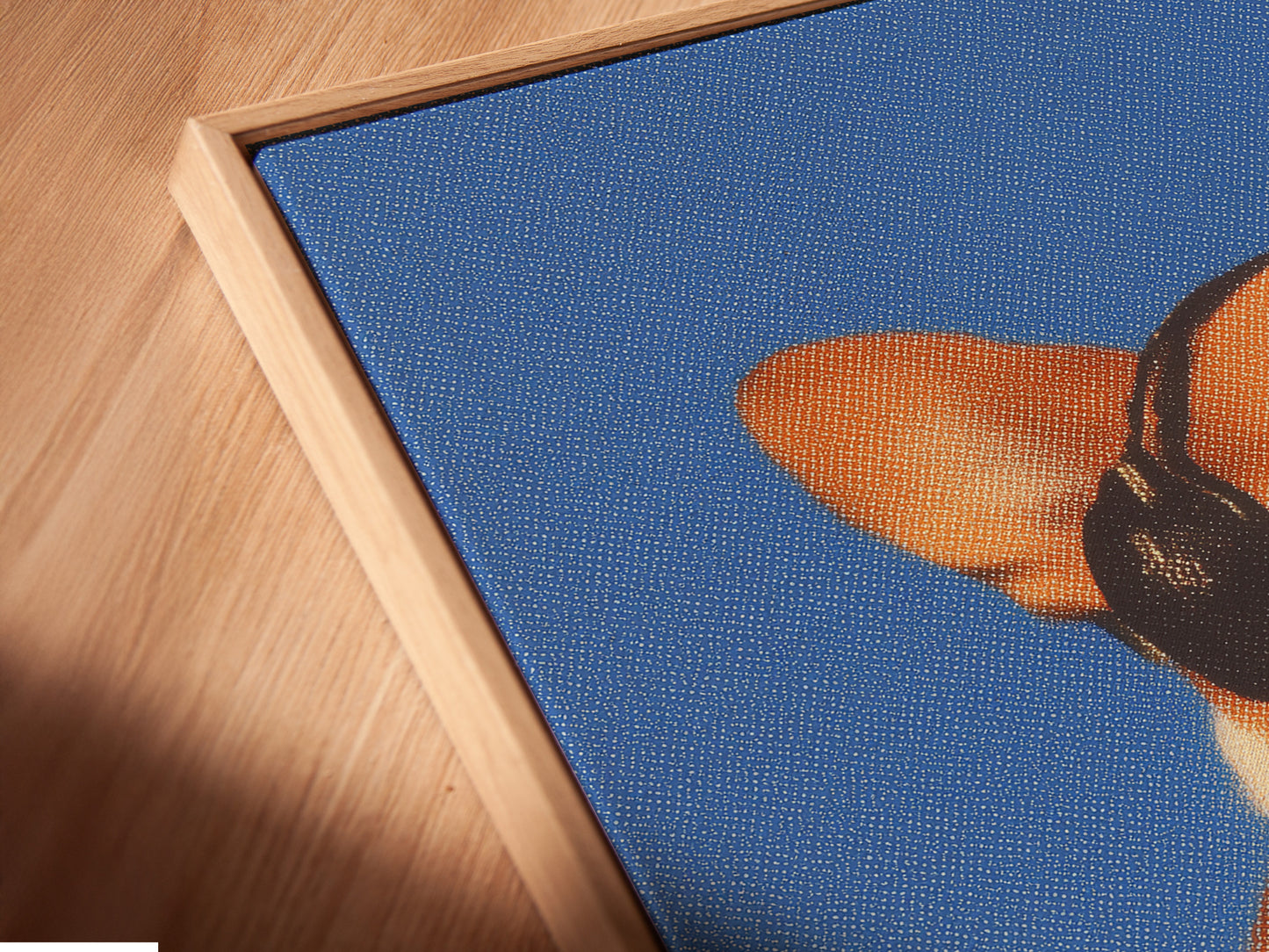 Angled close up of a Corgi Music Artwork Print in floating frame. Dog listening to headphones canvas wall art. A blue pet portrait for office wall decor. Ideal for dog lovers seeking unique wall art. Appreciate a touch of whimsy in your home.