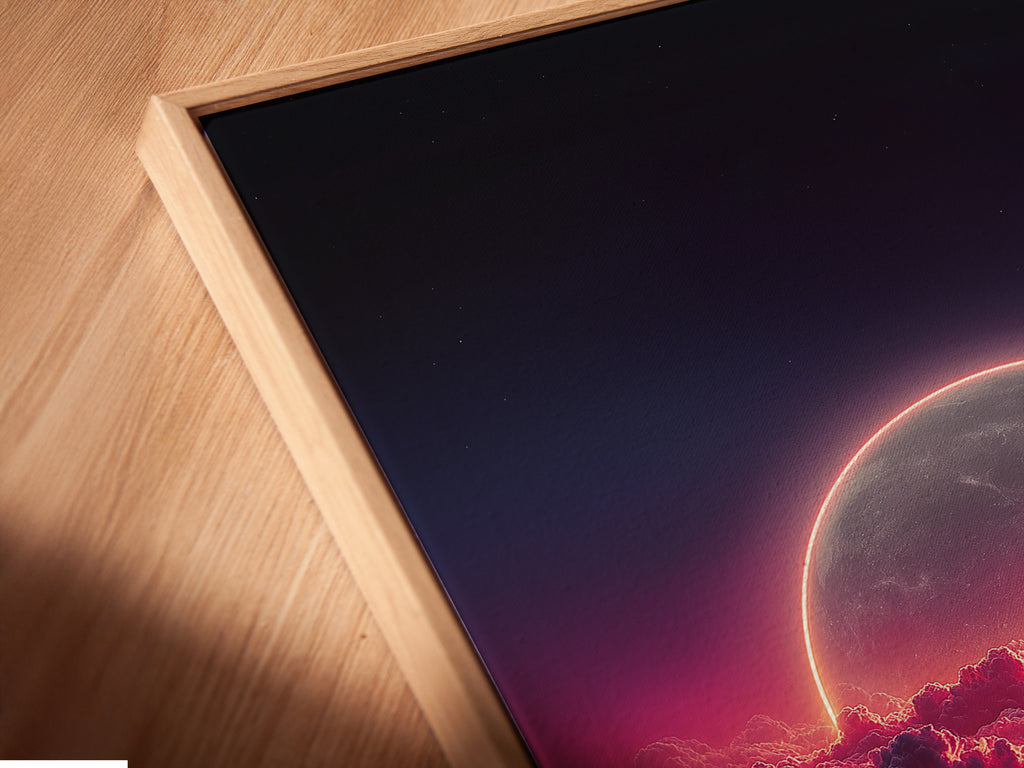 Close-up angled view of a canvas print. The artwork features a celestial moon with pink clouds. A floating frame adds a modern touch. Perfect for dreamy bedroom wall decor. This piece elevates any space with its cosmic charm.