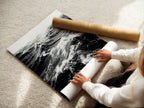 A woman is rolling a fine art poster paper. Our fine art paper ensures high quality prints. Perfect for ocean wave artwork and detailed sea prints. Order your fine art prints and posters today for your home decor.