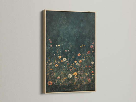 Floral artwork in an oak frame. The frame enhances the artwork adding a touch of elegance to the interior. The art piece features a field of colorful wildflowers with a dark backdrop. The artwork is displayed on a wall bathed in sunlight creating an appealing contrast.
