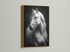 The White Horse Canvas Print is beautifully presented in a gold frame. This equestrian artwork adds a luxurious touch to any room. Perfect for those seeking refined animal wall art. This black and white art complements farmhouse and contemporary styles. Elevate your decor now.
