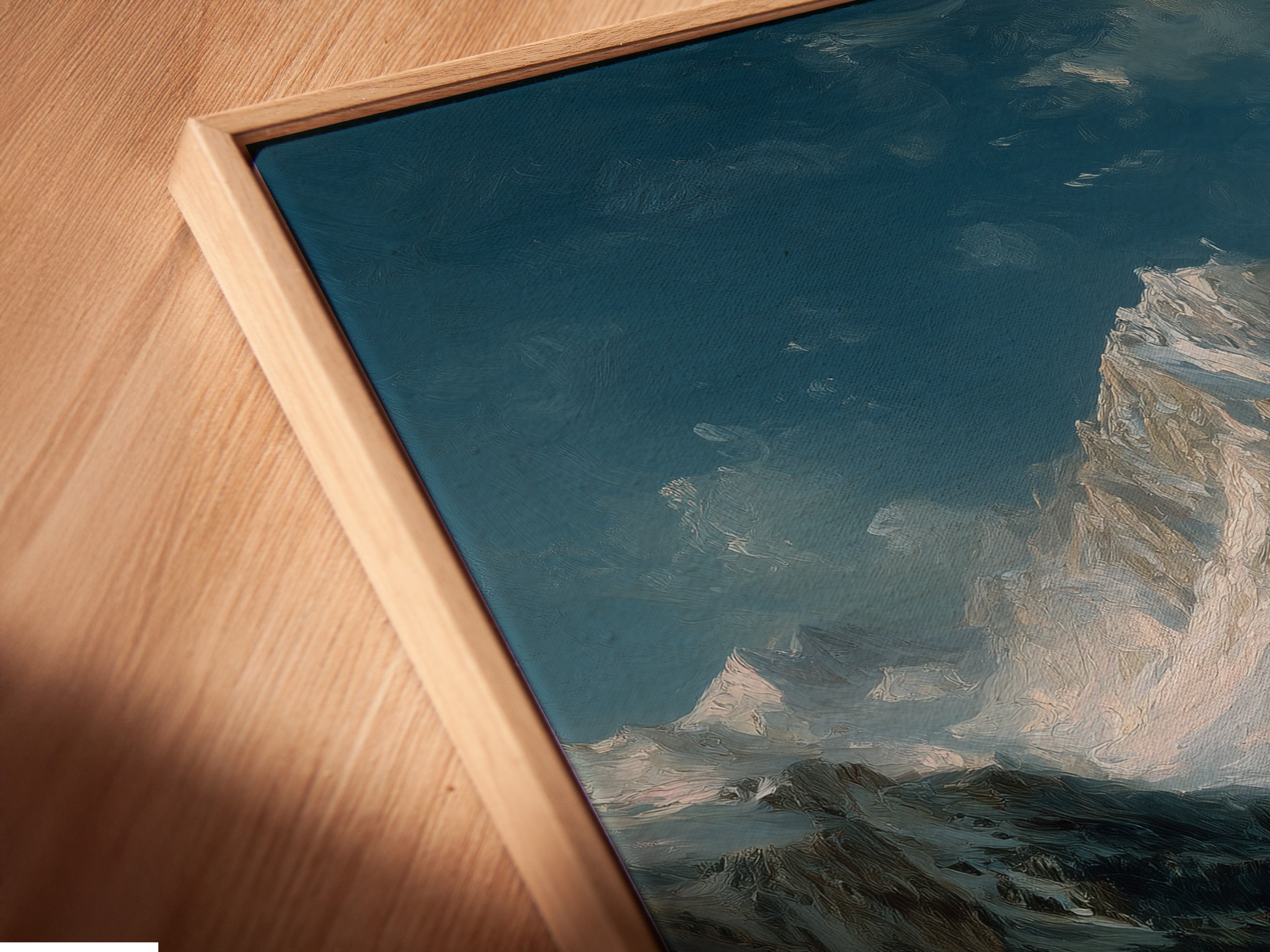 Close up angled view of a canvas print. The Alpine Village artwork is displayed in a floating frame. The winter landscape is perfect for a cozy cabin. The snow scene print enhances any space. The mountain village scene adds a touch of European charm.