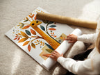 A woman carefully rolls a fine art poster paper. High-quality paper ensures the artwork remains pristine. Perfect for preserving and displaying your favorite prints. Experience the beauty of fine art poster paper.
