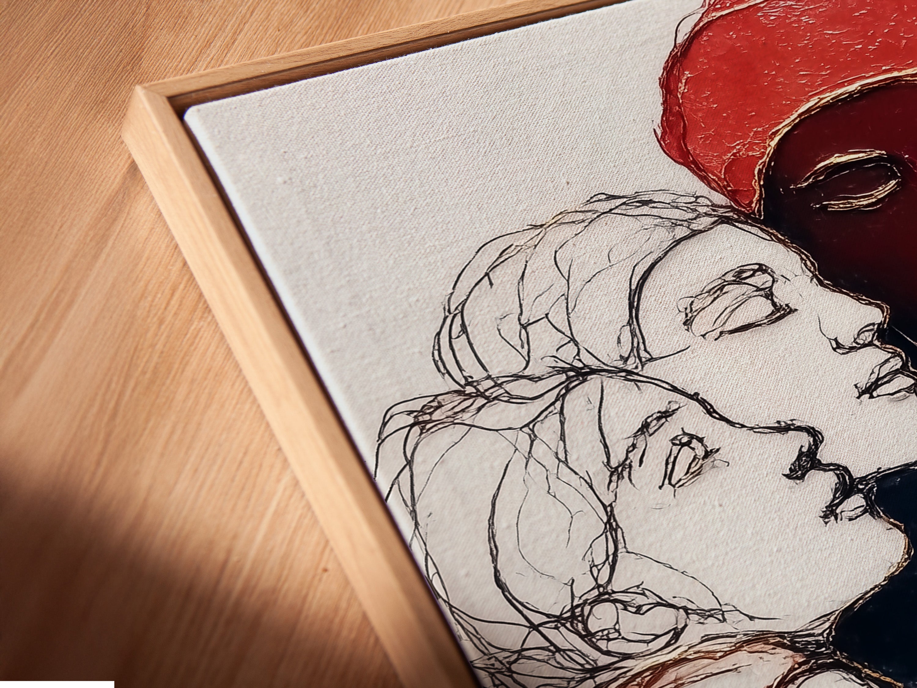 A close-up angled view shows a canvas print in a floating frame. This artwork features diverse female portraits. The colors are red and black contemporary. This style of artwork is ideal for office wall art. It makes a bold statement in any room.