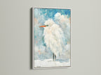 A white frame highlights the Heron coastal artwork. This clean frame complements minimalist beach house decor. It brightens any space. Discover this bird painting today