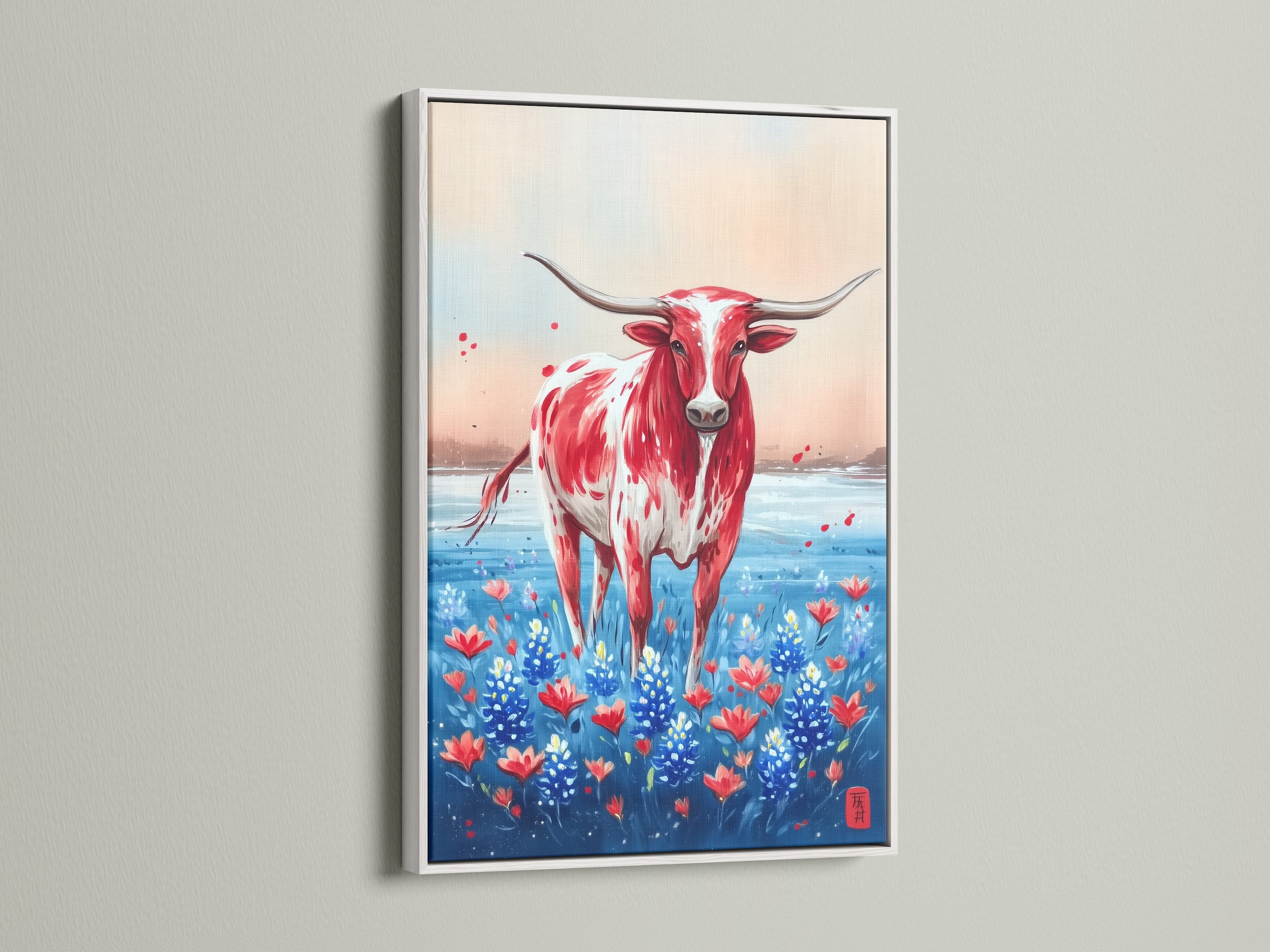 Texas Longhorn art in a white frame. The artwork depicts a red and white Longhorn standing among bluebonnets. Add a touch of country style to your space with this canvas print. A beautiful piece of western artwork.