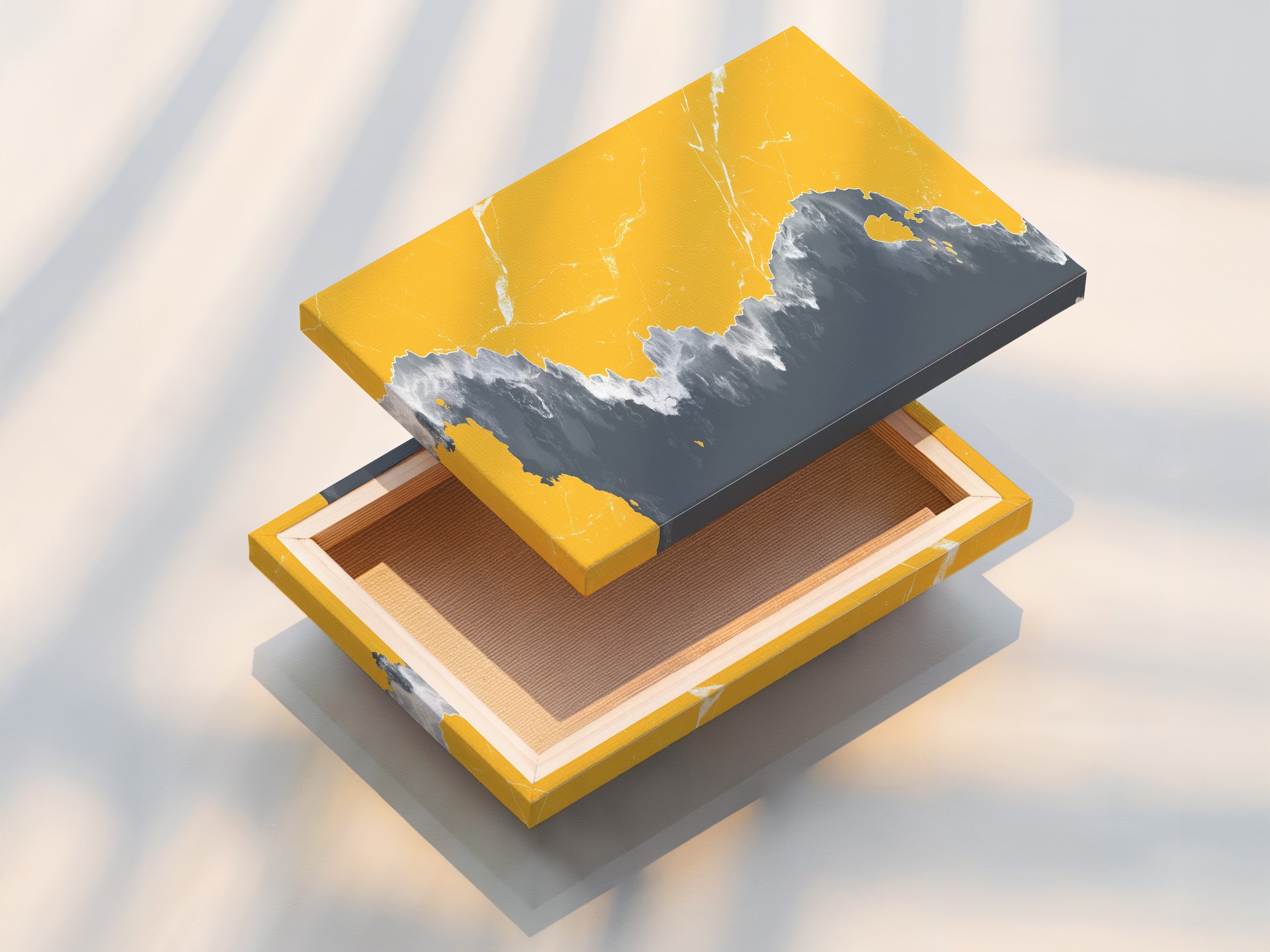 A beautifully stretched canvas print on display. Showcasing the texture and depth of the artwork. This abstract coastline art combines mustard yellow and gray. Ready to hang and transform your living space with modern seascape.