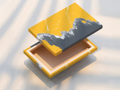 A beautifully stretched canvas print on display. Showcasing the texture and depth of the artwork. This abstract coastline art combines mustard yellow and gray. Ready to hang and transform your living space with modern seascape.