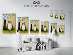 A size comparison chart is displayed in an interior setting. The chart illustrates available sizes for the whimsical cat artwork print. This peaceful garden canvas wall art is a cute animal illustration.