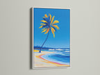 Tropical coastal canvas print with a white frame. The artwork depicts a palm tree beach scene. This ocean wave art brings a fresh nautical decor element to your space. The white frame offers a clean modern look for this beach wall decor.