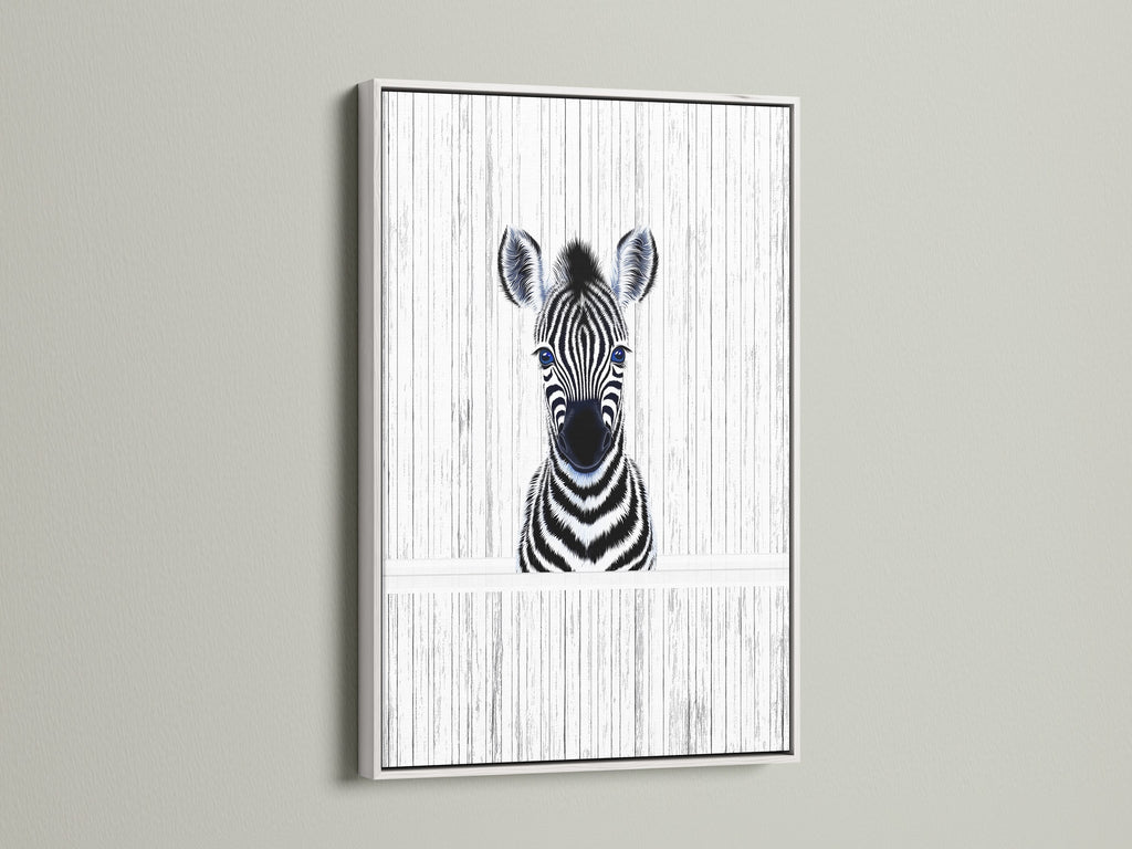 A delightful Baby Zebra artwork in a white frame. The black and white animal art complements kids room decor. This zebra poster brings a minimalist touch to a safari nursery. The white frame adds a clean contemporary look.
