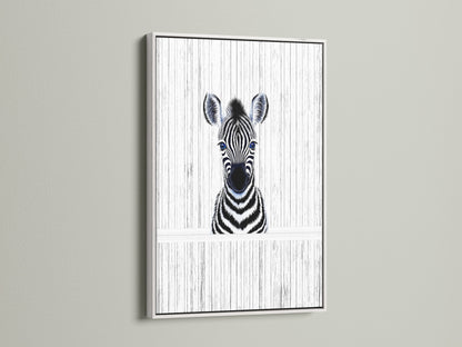 A delightful Baby Zebra artwork in a white frame. The black and white animal art complements kids room decor. This zebra poster brings a minimalist touch to a safari nursery. The white frame adds a clean contemporary look.