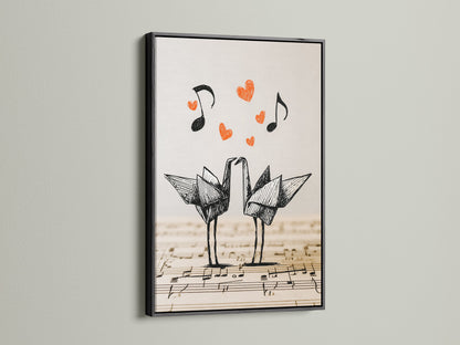 Black framed origami cranes artwork on display. The artwork features two origami cranes on a music sheet. Red hearts and music notes float above. The black frame provides a bold contrast to the minimalist art.