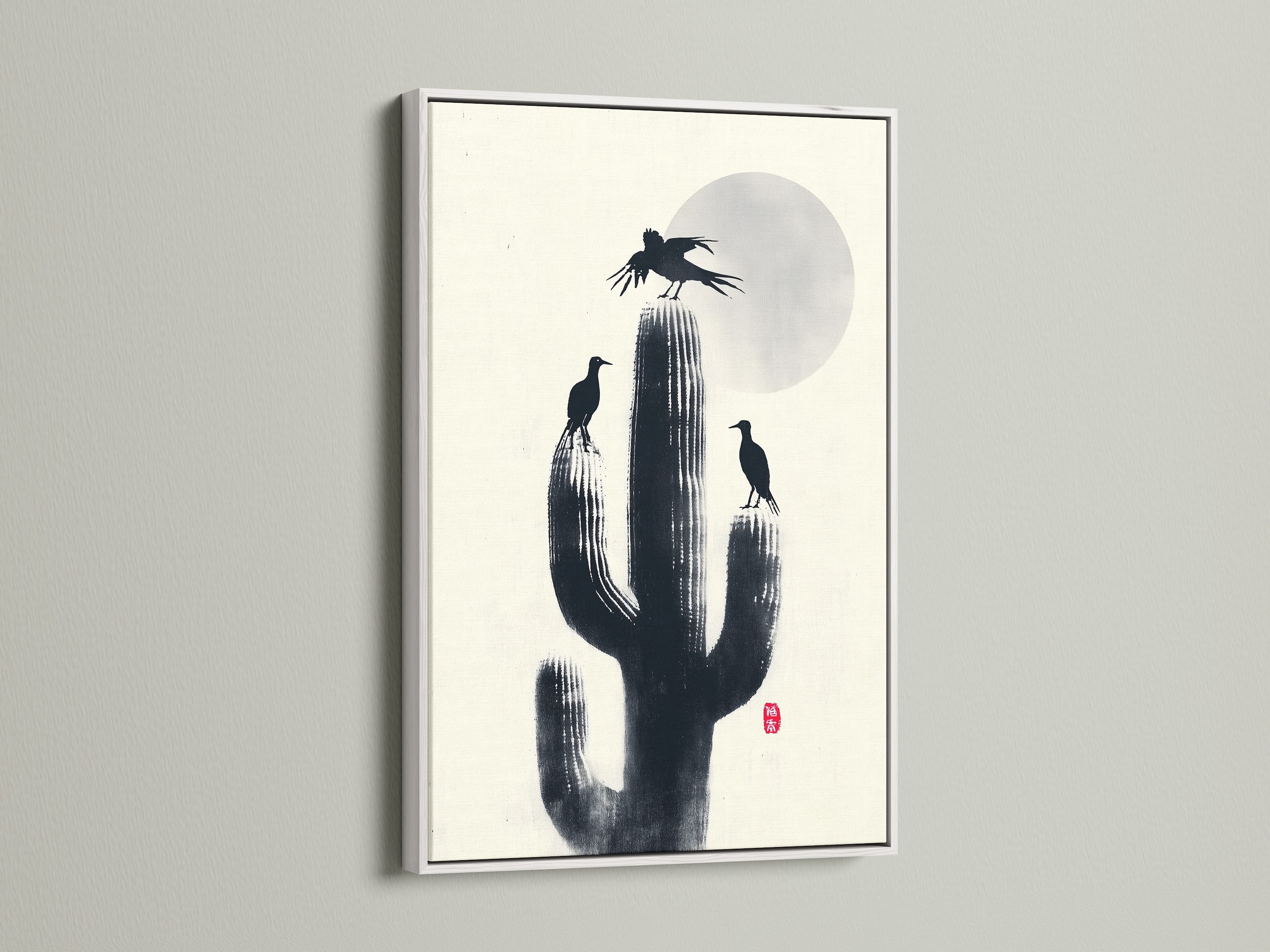 A minimalist Cactus Birds artwork print in a white frame. Black silhouettes of birds and cactus create a zen atmosphere. Ideal southwestern decor for your study room. This nature canvas adds refined style.