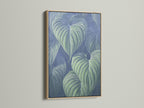 This is a tropical leaf art piece in an oak frame. The blue green botanical wall art adds a modern touch. It's great plant art for any room. The oak frame enhances this nature canvas art.