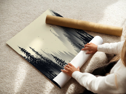 A woman carefully rolls a fine art poster paper of forest artwork. The monochrome nature print is ready for framing. This misty woodland wall art is perfect for any space. Explore black and white artwork for your home. Discover nature wall art options.