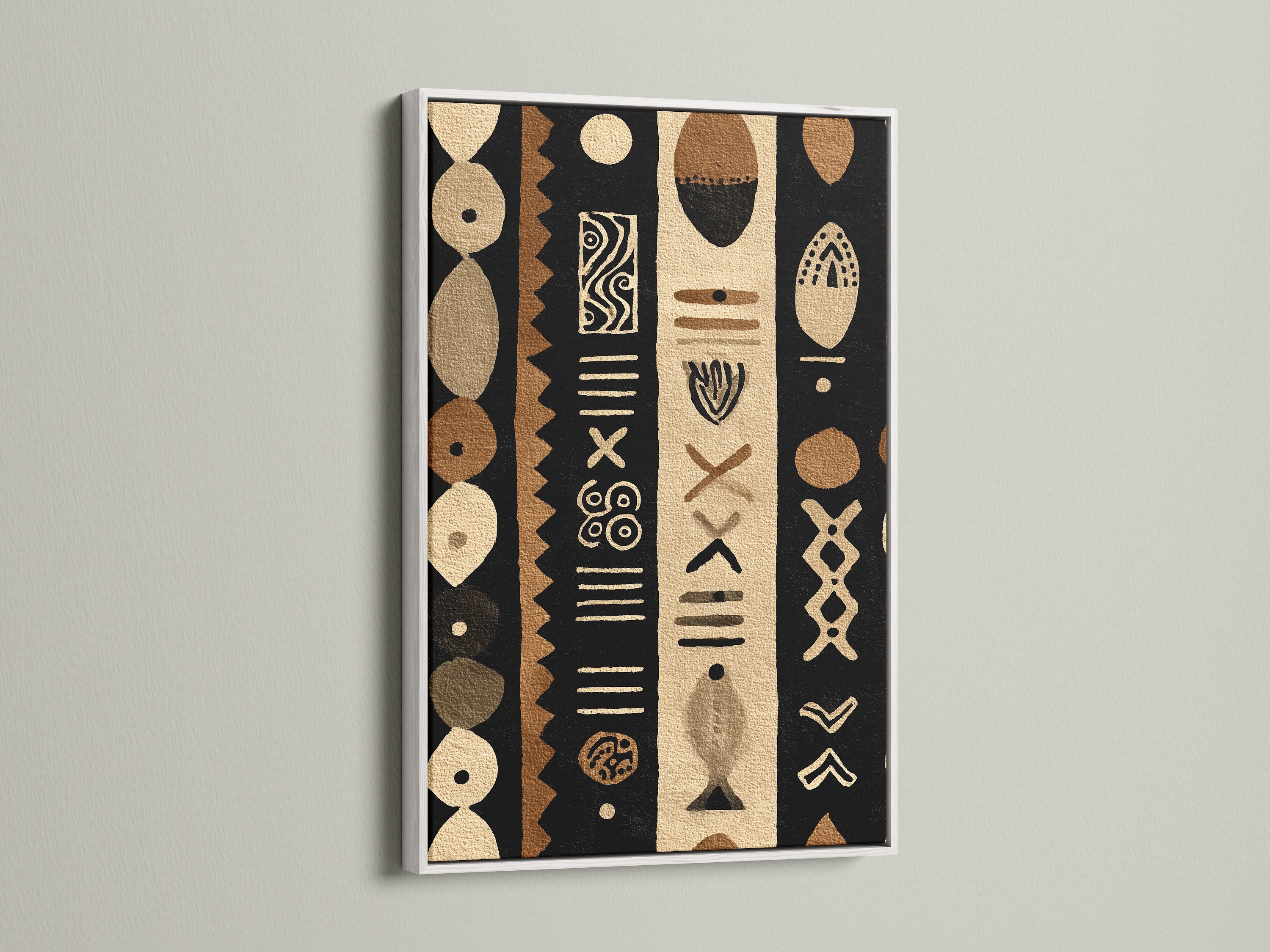 A white frame surrounds a striking tribal artwork. The contrast between the white frame and the tribal artwork creates a clean modern look. The artwork incorporates black brown and beige colors. This piece can brighten any space.