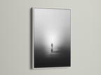 A white frame surrounds this minimalist solitude canvas print. The black and white artwork captures a foggy water reflection. Ideal for a peaceful artwork display. It complements contemporary wall decor.