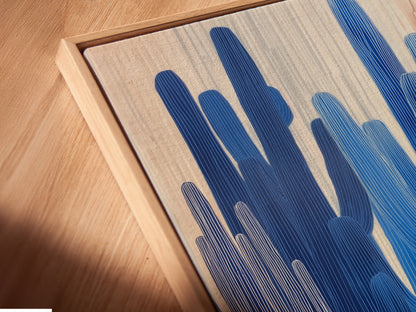 Angled close up of a canvas print in a floating frame. A modern way to display blue botanical artwork. Perfect for showcasing desert canvas prints. Enhance your home office decor with floating frames.