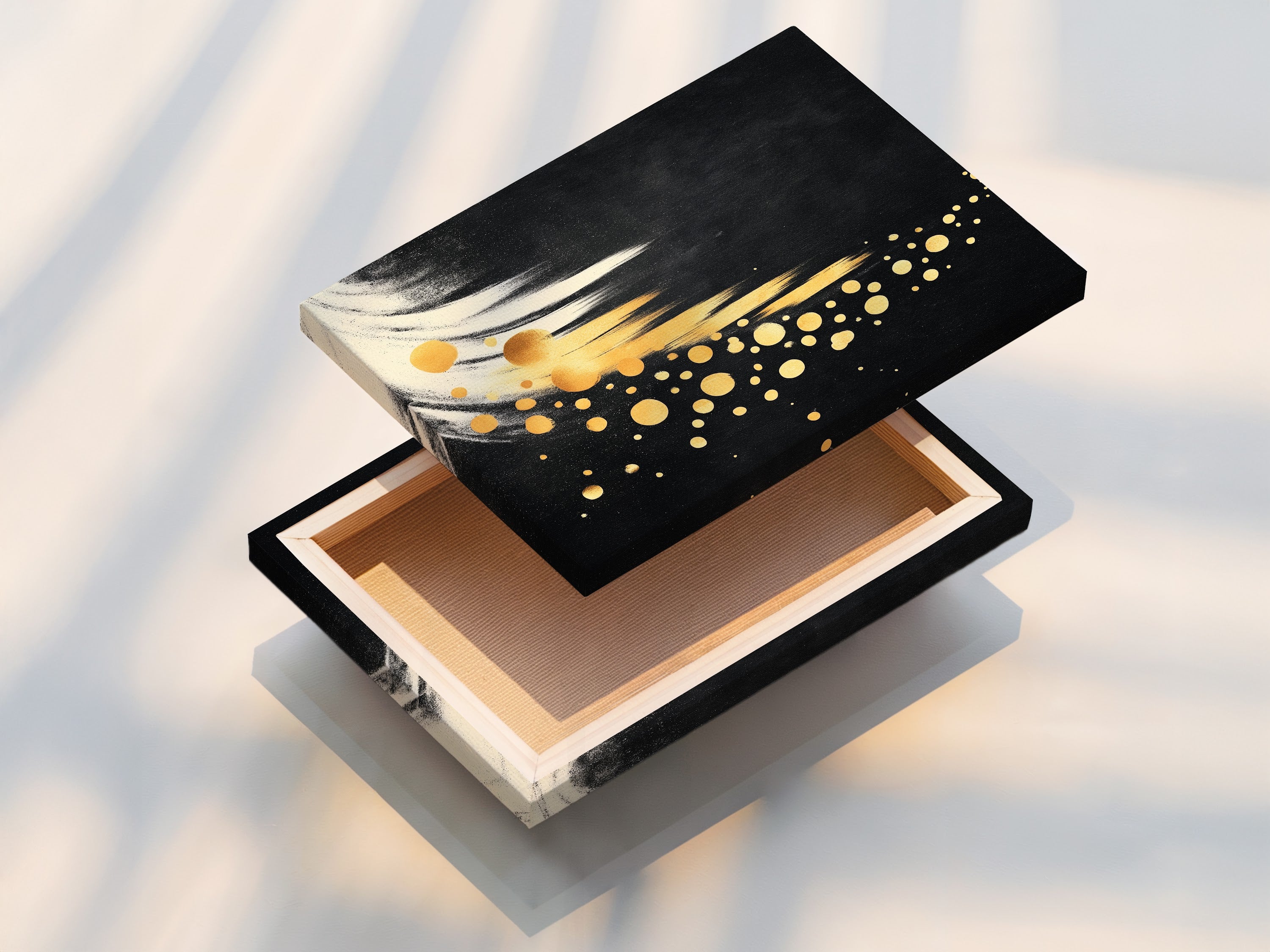 A stretched canvas print displays black and gold abstract art. This modern canvas art is ready to hang. It adds a contemporary touch to any room. Perfect for minimalist eclectic or Scandinavian styled spaces. Ideal for home or office.