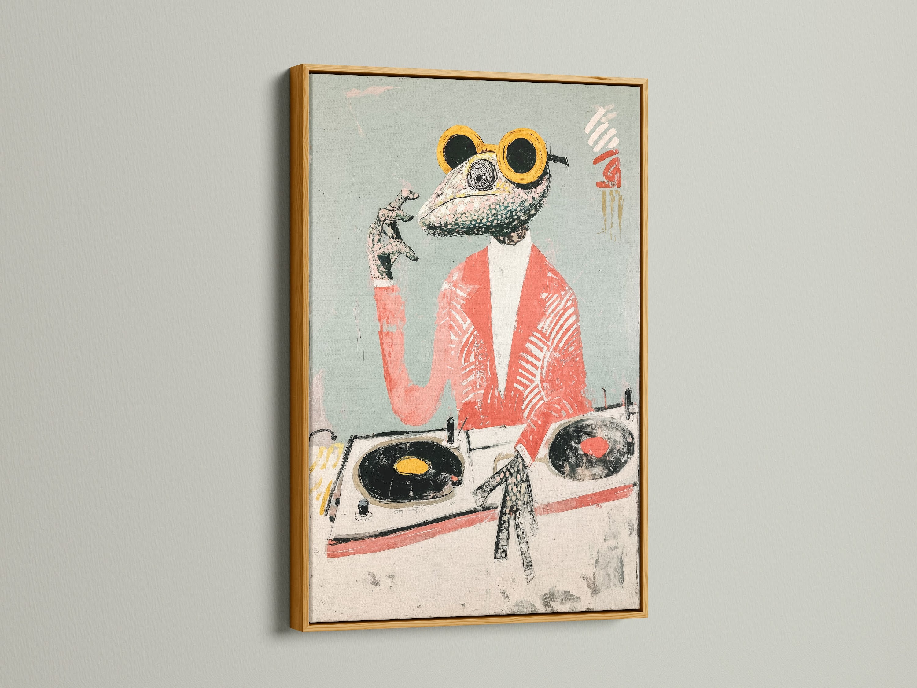 A framed Frog DJ art print is presented in a gold frame. The gold frame adds a touch of elegance to the vintage music art. It enhances the coral pink art and funny animal artwork. This frame elevates the retro animal art.