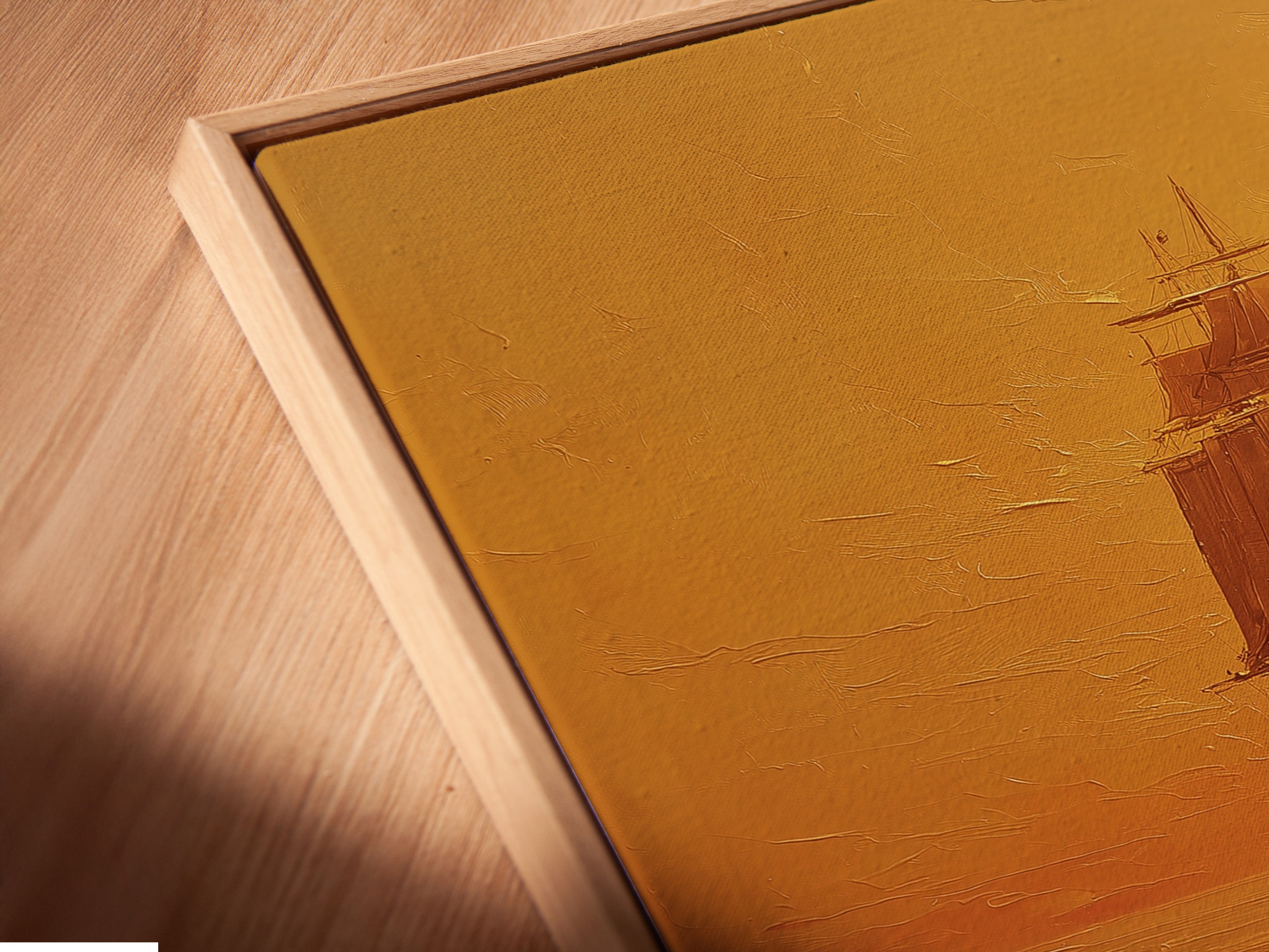 Angled close-up reveals a canvas print in a floating frame. The seascape artwork features a ship sailing under the sun. The floating frame gives the artwork a gallery-like appearance. The artwork enhances its visual appeal. The canvas print adds texture and depth.