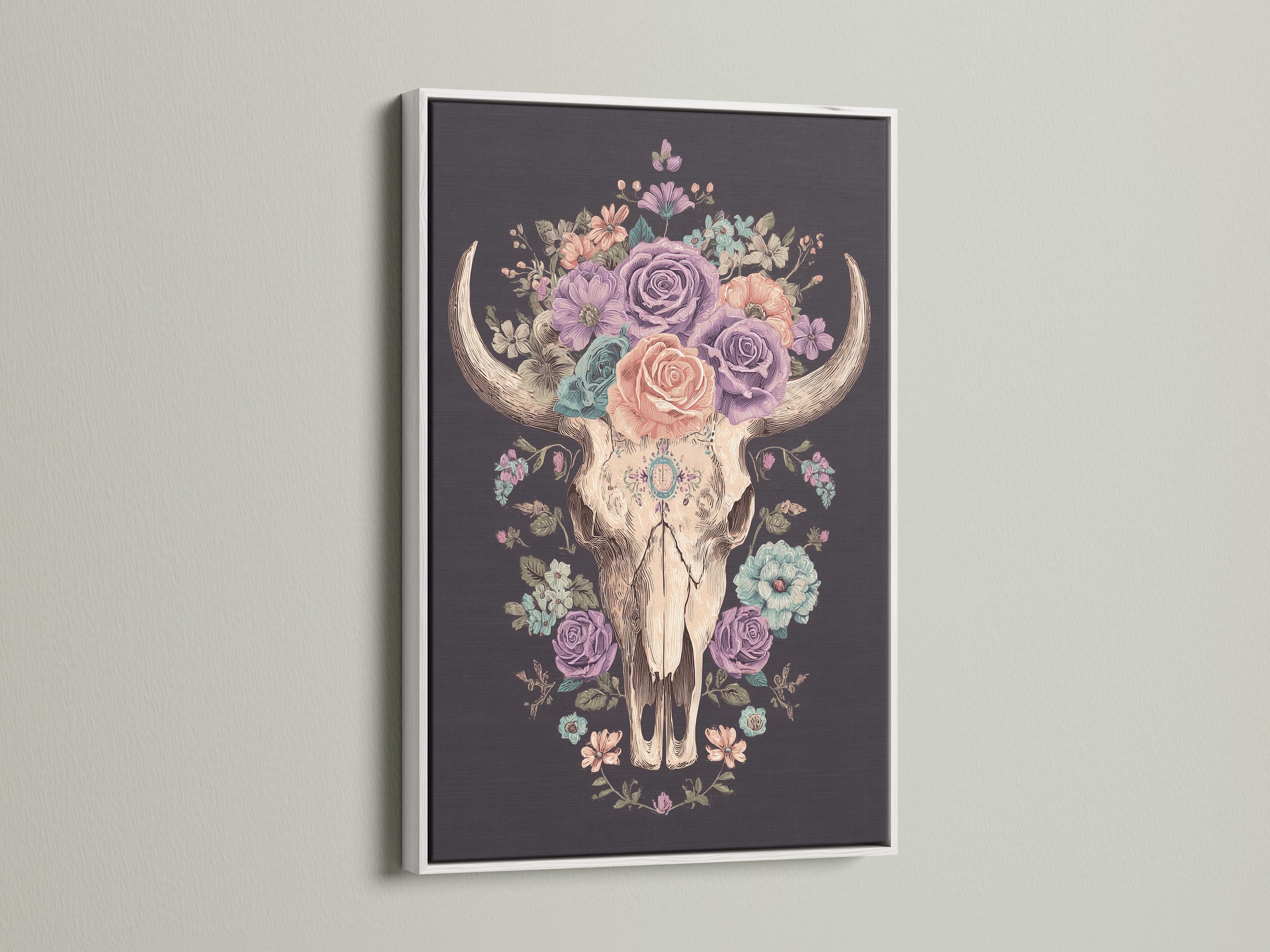Artwork of a floral bull skull in a white frame. The art print features a skull adorned with colorful roses. This artwork is framed in a clean white frame. The white frame enhances the artwork. Perfect wall art for any space.