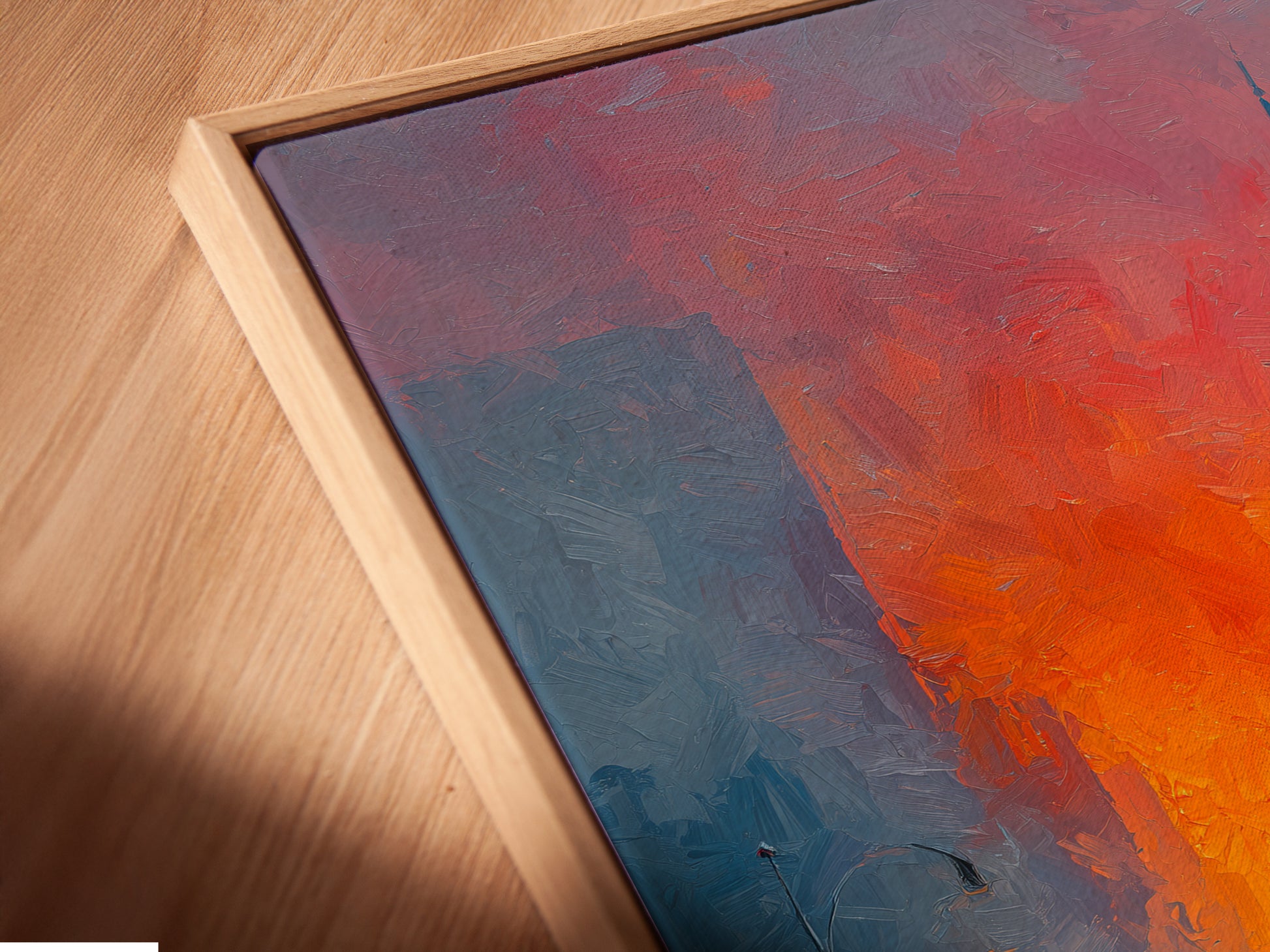 An angled close-up highlights a canvas print in a floating frame. The floating frame gives the artwork depth. It's ideal for displaying an Empire State Building print. This style suits contemporary homes.