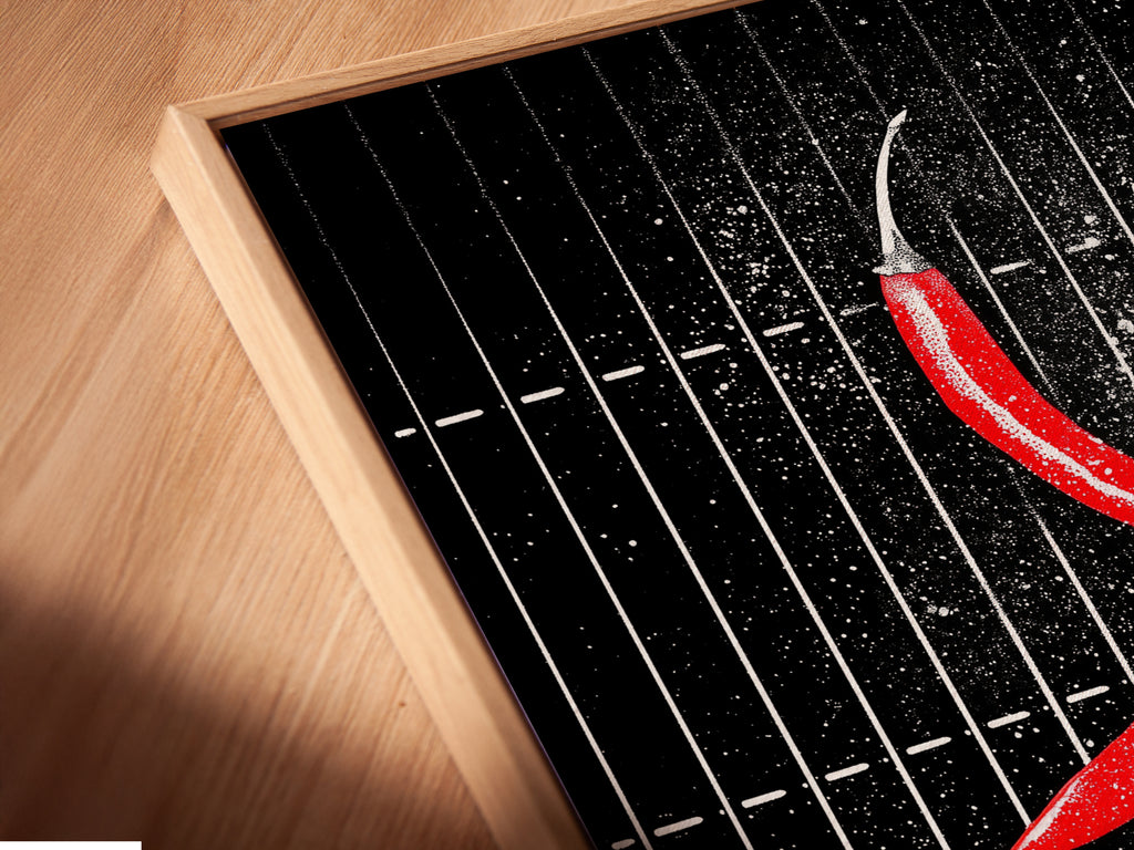 Close-up angled view of a canvas print in a floating frame. The chili pepper artwork is elevated. The floating frame adds depth. This modern art is perfect for any space. Ideal for homeowners and interior designers.
