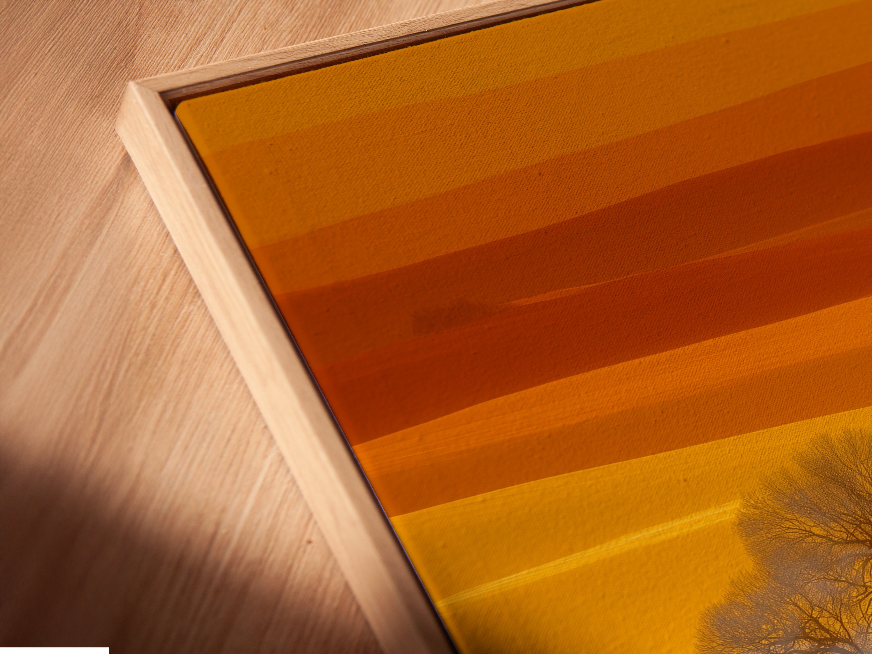 A close-up angled view shows a canvas print in a floating frame. The farmhouse landscape artwork features golden field wall art. This country house photography is perfect for any room. Enhance your home with this scenic artwork.