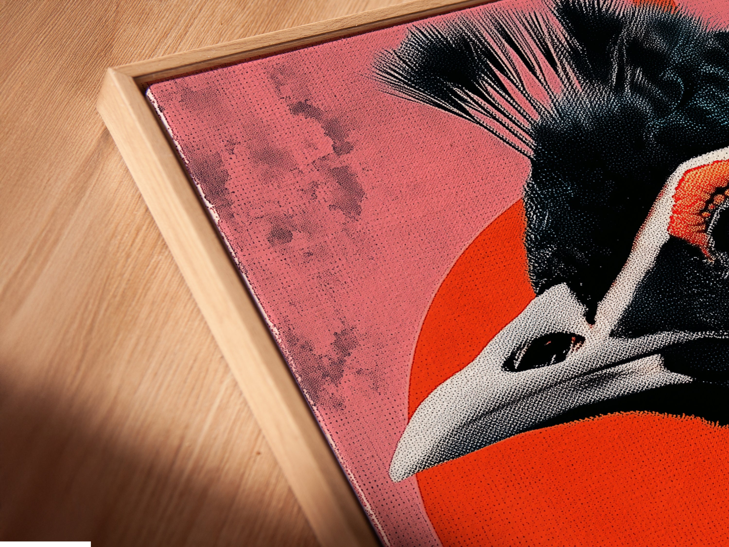 Close-up of a canvas print in a floating frame. The Exotic Bird artwork features teal and coral colors. It is a perfect piece of modern wall art. Ideal for boutiques and studios. Add a vibrant touch to your space with this contemporary art.