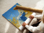 A woman is rolling a fine art poster paper. The poster paper is high-quality and durable. This paper ensures the artwork looks its best. Fine art poster paper is perfect for displaying artwork. The paper preserves the art.