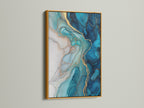 A gold frame enhances the beauty of this blue abstract art. This fluid acrylic wall art features stunning teal and gold marble patterns. Bring a touch of luxury to your living room with this contemporary artwork. Perfect for homeowners and interior designers seeking elevated wall decor.