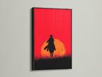 Cowboy Sunset Canvas Print with black frame. This western canvas print features a cowboy silhouette against a red orange sunset. Perfect for adding rustic charm to your living room or office. Elevate your space with this captivating artwork.