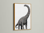 Dinosaur wall art featuring a minimalist brontosaurus canvas print. It is perfect modern nursery decor for a kids room. The artwork has a gold frame. This prehistoric art is great for studios.