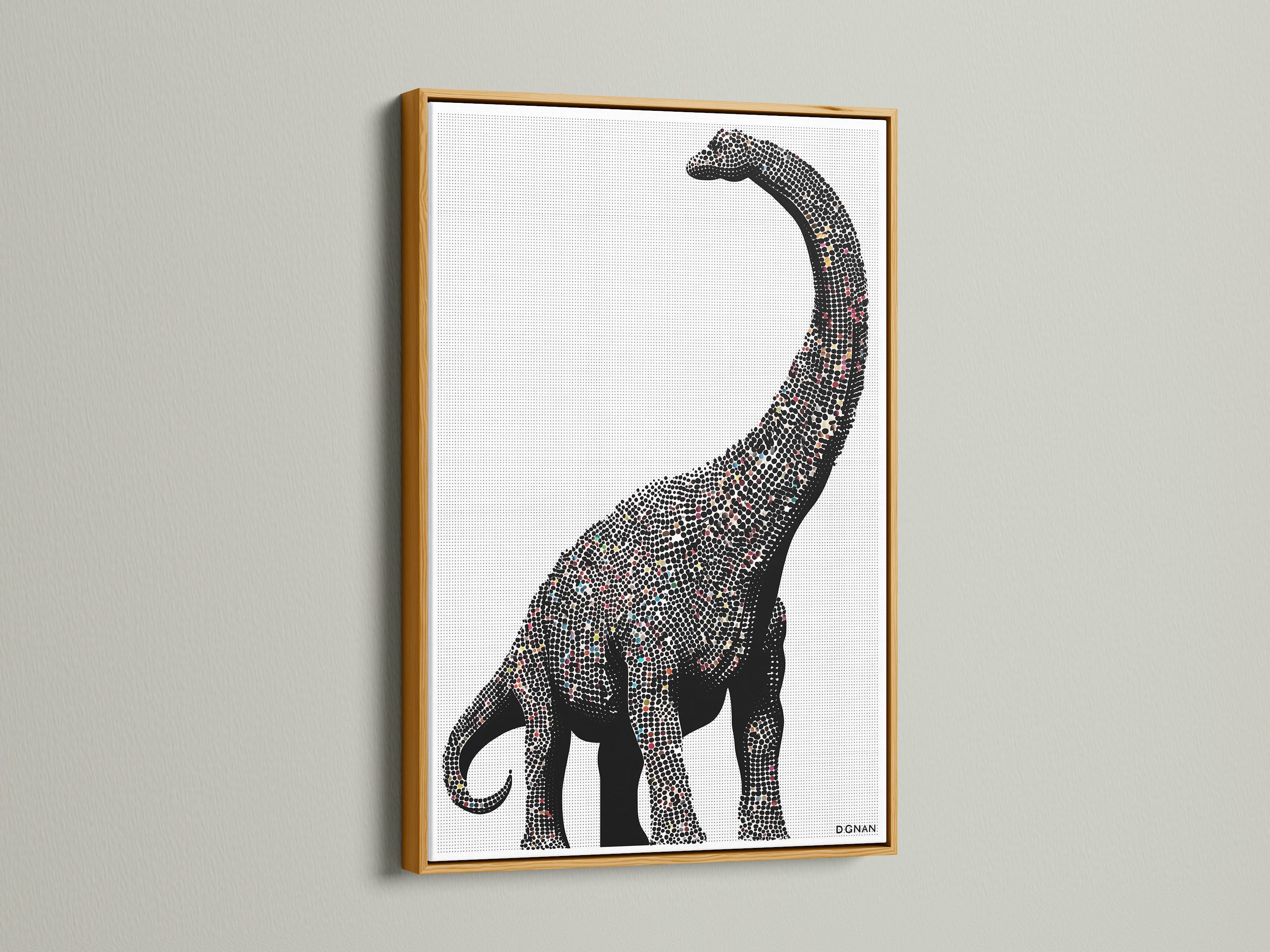 Dinosaur wall art featuring a minimalist brontosaurus canvas print. It is perfect modern nursery decor for a kids room. The artwork has a gold frame. This prehistoric art is great for studios.