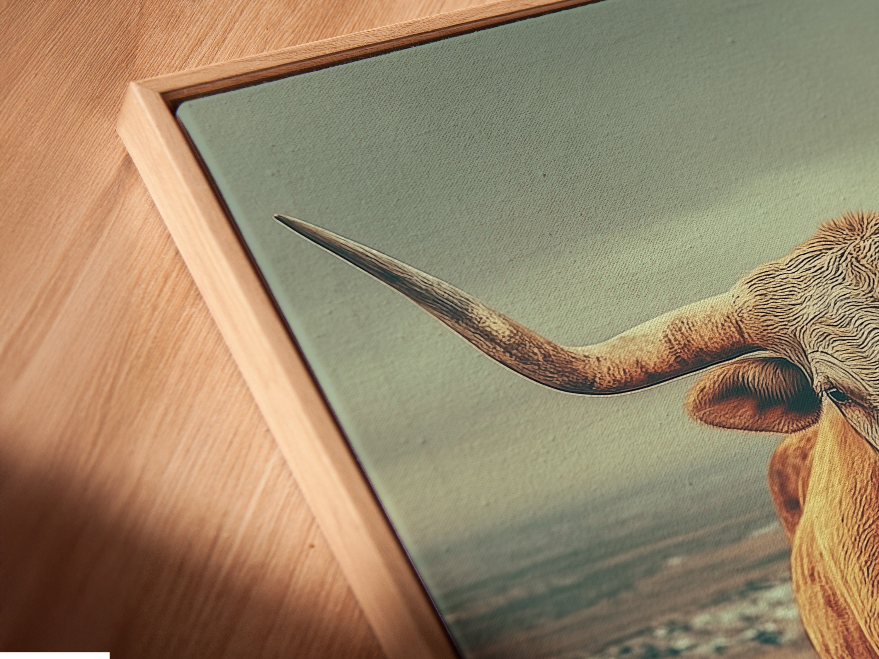 Close up of a canvas print in a floating frame. The Highland Cow art is beautifully presented. This vintage landscape is perfect for rustic home decor. Farm wall art is a great addition to any space. Get yours today.