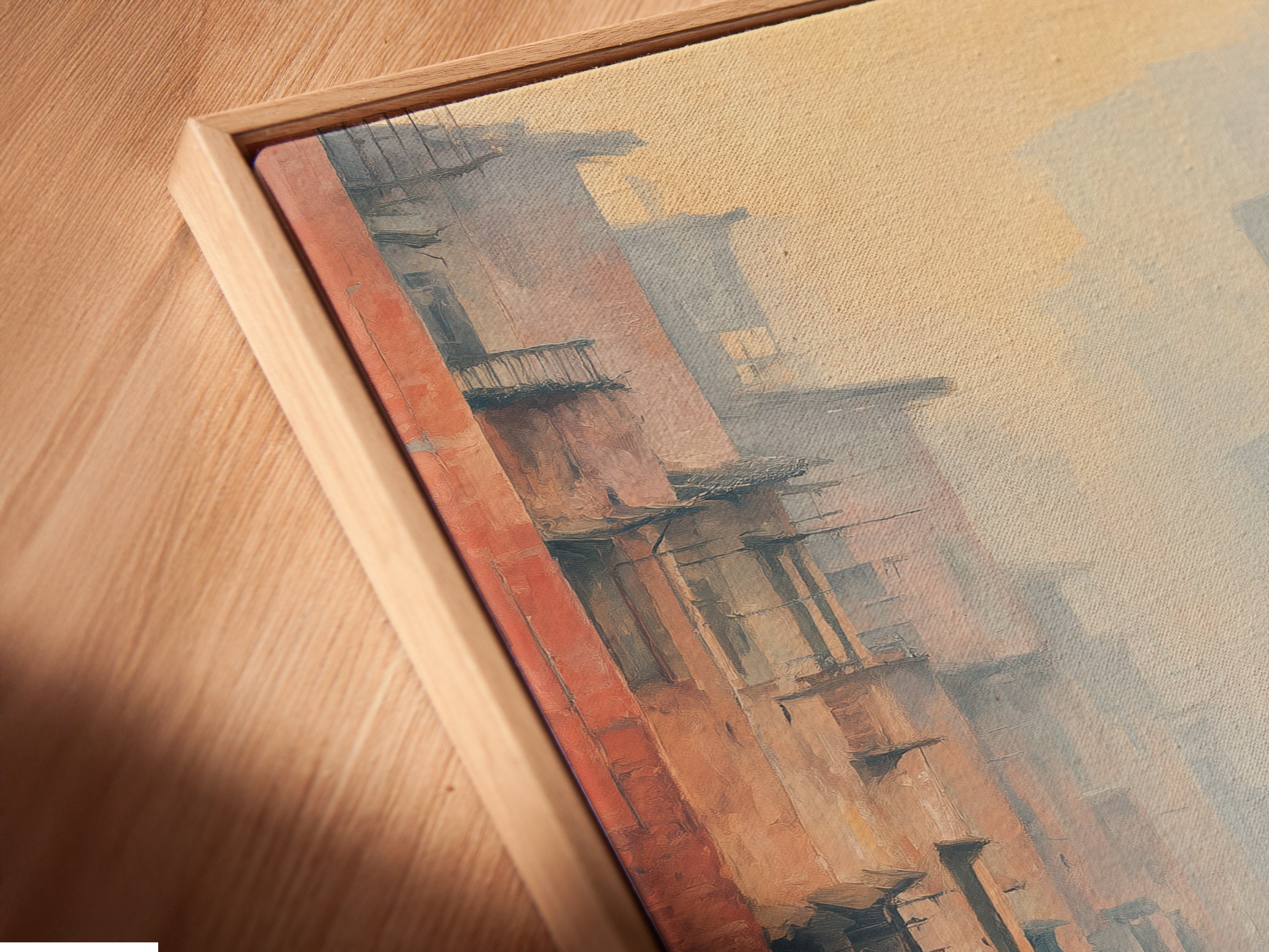 A close up angled view of a canvas print in a floating frame. This contemporary artwork showcases an urban canvas print ideal for hallway decor. The floating frame enhances the misty cityscape art creating an eye catching display.